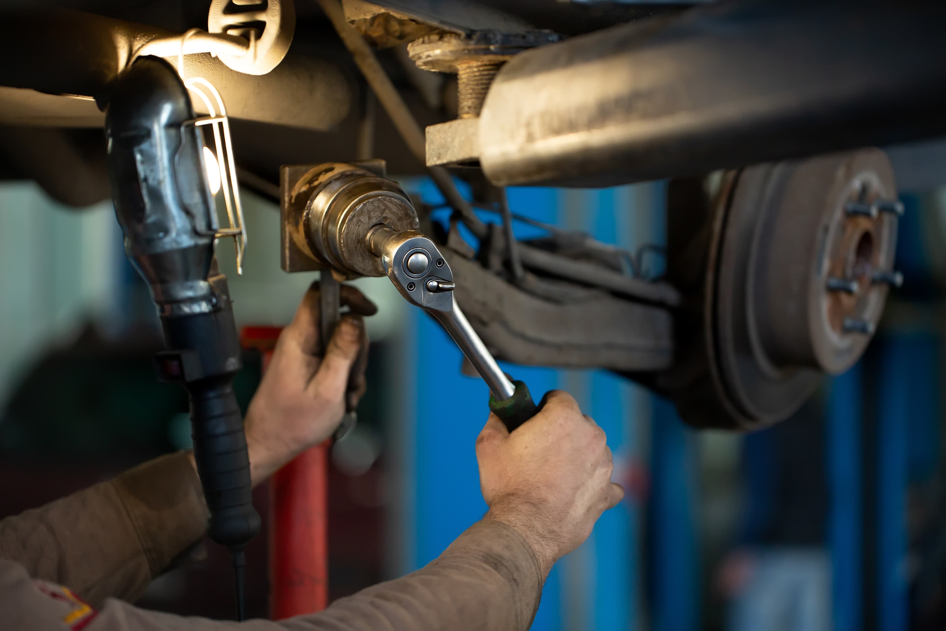 Mobile automotive technician performing vehicle inspection and repair